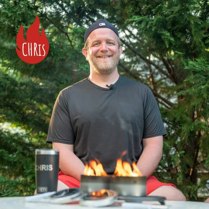 Chris, co-founder of City Bonfires, with a lit City Bonfire in front of him