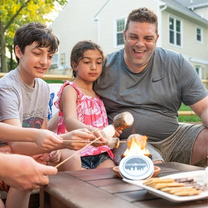 A family roasting s'mores around a City Bonfire