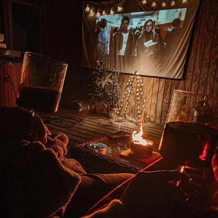 An outdoor movie night around a small fire