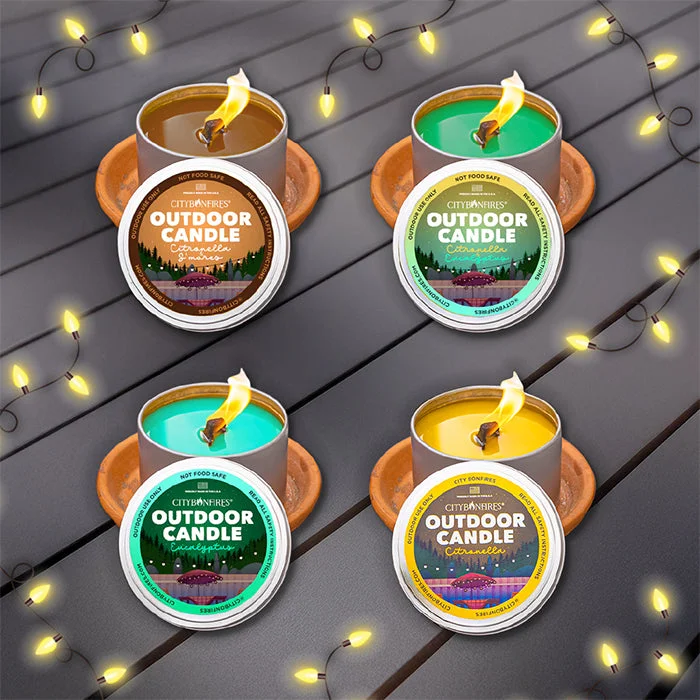 The Outdoor Candle Variety Pack on a table with string lights